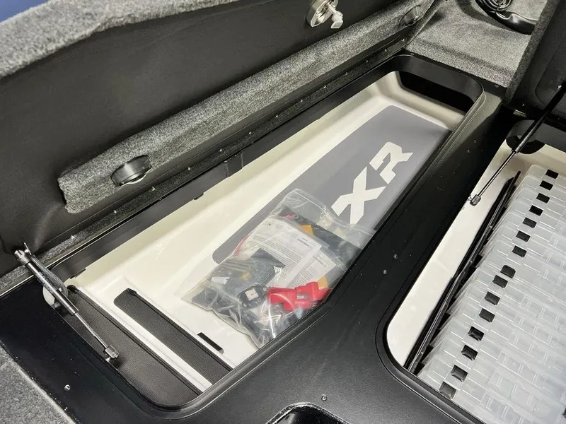 Slide: The Image of Storage compartment of 2025 Skeeter FXR20 PRO boat with organized gear and accessories. - 16