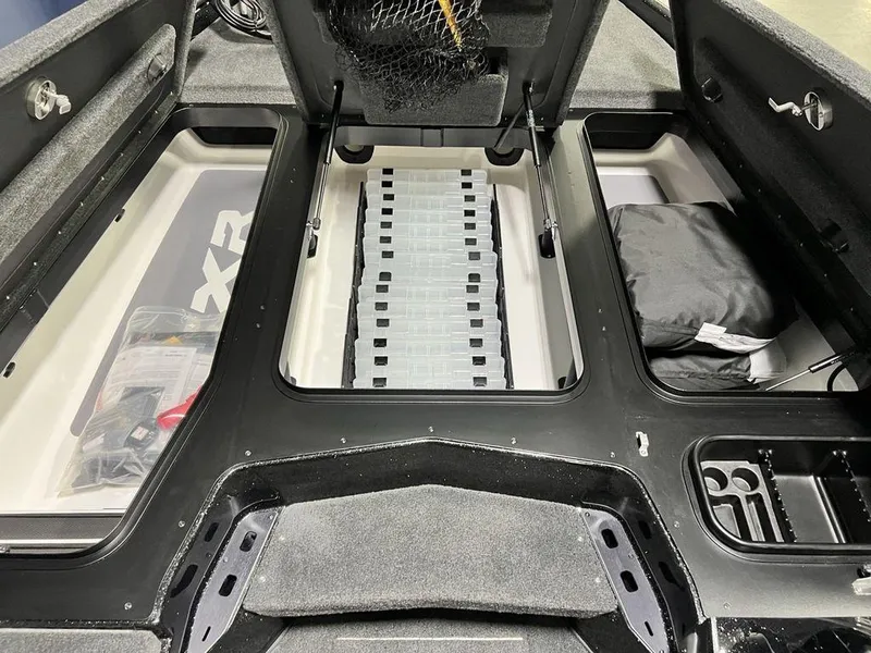 Slide: The Image of 2025 Skeeter FXR20 PRO boat interior with storage compartments and fishing gear. - 9