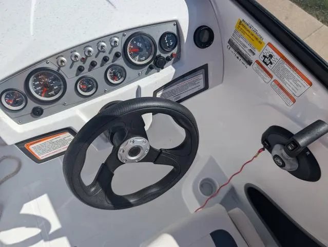 Slide: The Image of 2021 Tracker 450 TF boat dashboard with steering wheel and control panel. - 11