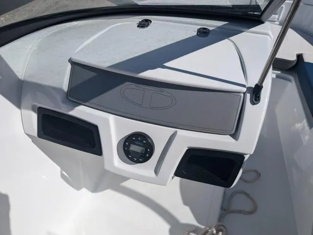 Slide: The Image of 2021 Tracker 450 TF boat dashboard with control panel and storage compartments. - 13