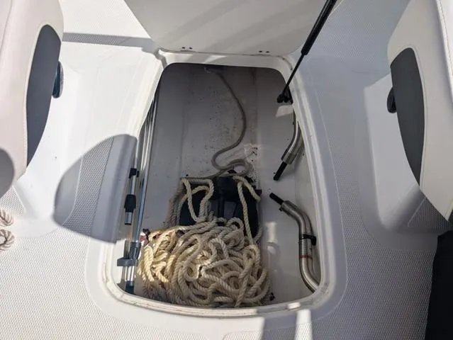 Slide: The Image of Open storage compartment in 2021 Tracker 450 TF boat with ropes and equipment. - 16