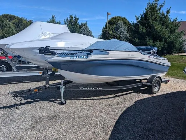 Slide: The Image of 2021 Tracker 450 TF boat on trailer, covered, parked outdoors. - 17
