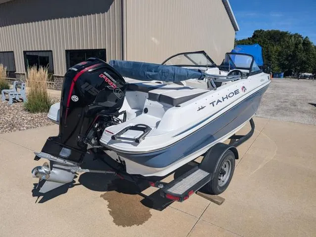 Slide: The Image of 2021 Tracker 450 TF boat on trailer, parked outdoors near a building. - 4