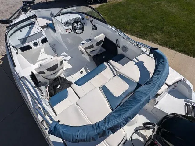Slide: The Image of 2021 Tracker 450 TF boat interior with white and blue seating, steering wheel, and dashboard. - 6