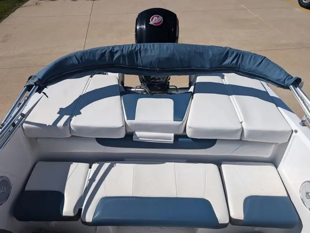 Slide: The Image of 2021 Tracker 450 TF boat with cushioned seating and outboard motor. - 9