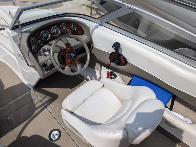 Slide: The Image of 2007 Crownline 190 SS boat interior with white seating and dashboard controls. - 10