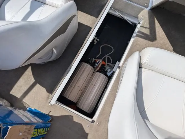 Slide: The Image of 2007 Crownline 190 SS boat interior storage compartment with white seats and accessories. - 13
