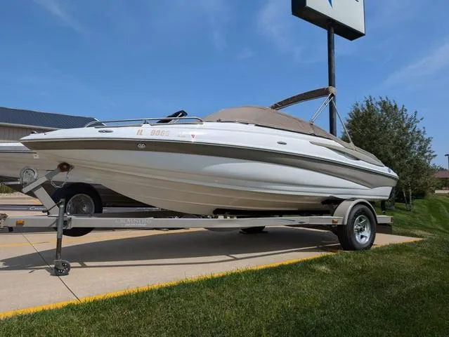 Slide: The Image of 2007 Crownline 190 SS boat on trailer, parked outdoors under clear sky. - 14