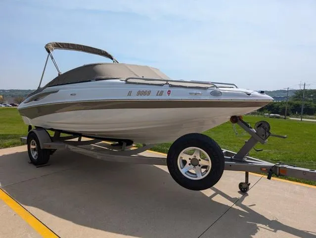Slide: The Image of 2007 Crownline 190 SS boat on trailer, parked outdoors. - 15