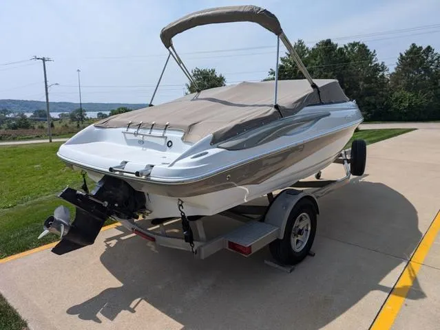 Slide: The Image of 2007 Crownline 190 SS boat on trailer with cover, parked outdoors. - 16