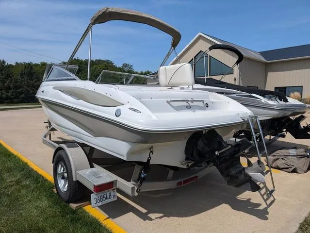 Slide: The Image of 2007 Crownline 190 SS boat on trailer, parked outdoors under clear sky. - 4