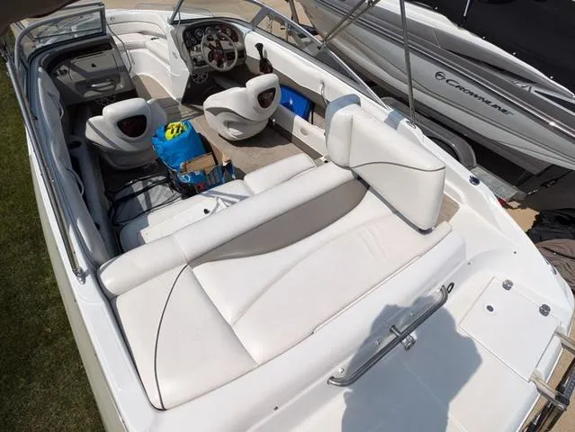 Slide: The Image of 2007 Crownline 190 SS boat interior with white seating and dashboard controls. - 6