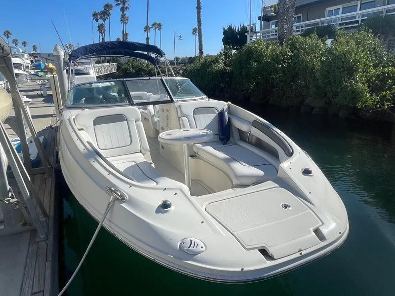 Slide: The Image of 2010 Sea Ray 260 Sundeck boat docked in sunny marina. - 0