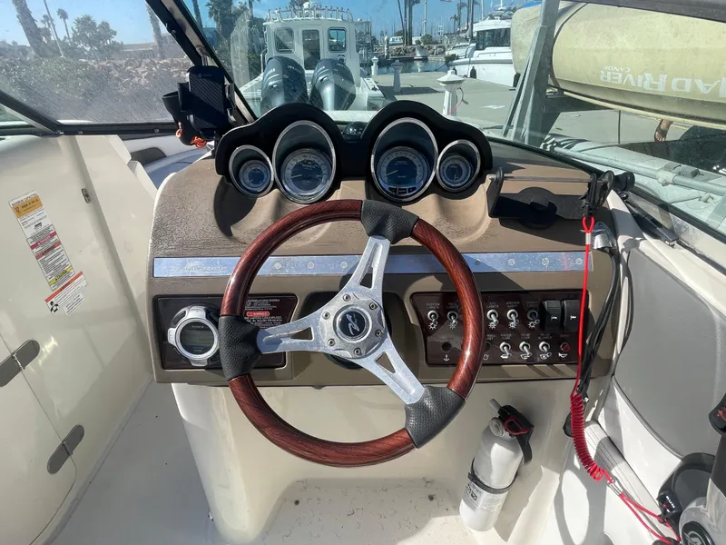 Slide: The Image of 2010 Sea Ray 260 Sundeck dashboard with steering wheel and gauges. - 10