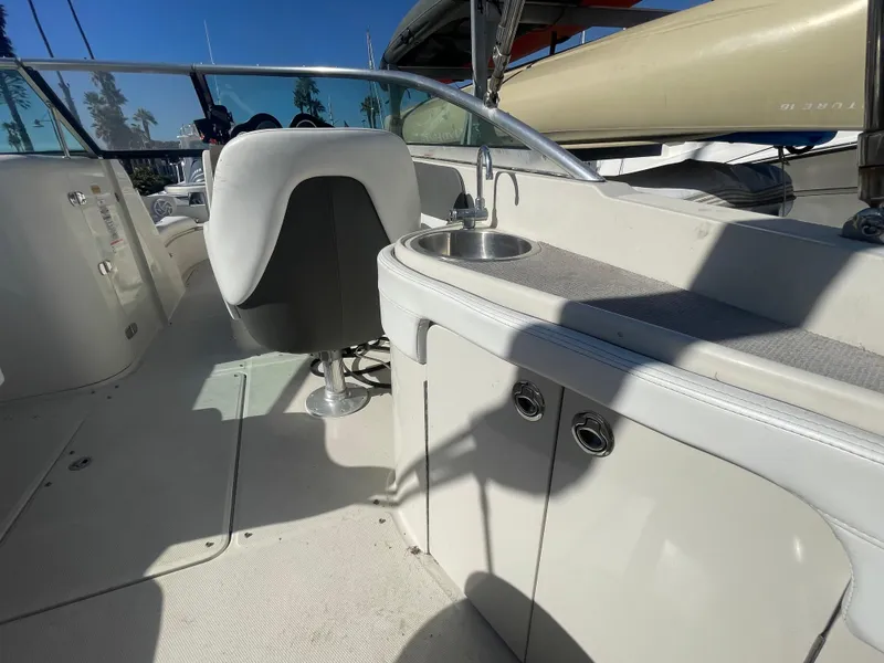 Slide: The Image of 2010 Sea Ray 260 Sundeck interior with seating and sink, showcasing sleek design. - 12