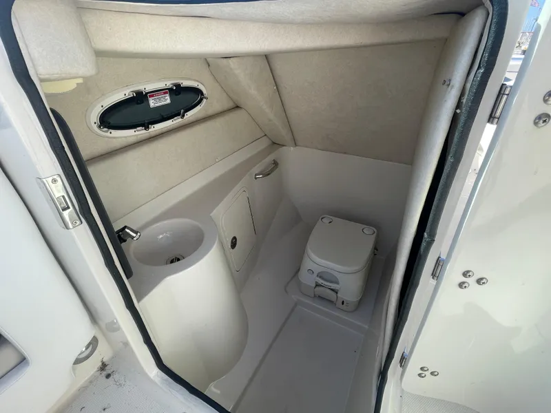 Slide: The Image of 2010 Sea Ray 260 Sundeck boat interior bathroom with sink and toilet. - 13