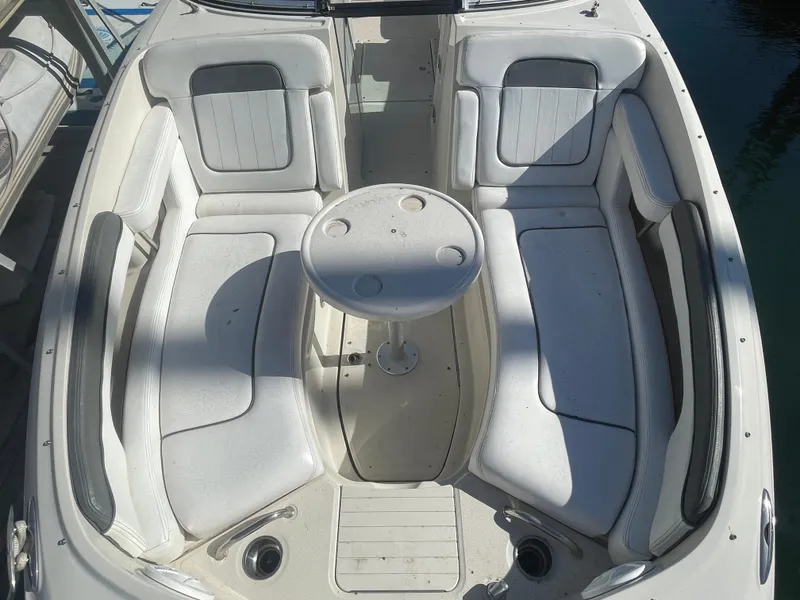 Slide: The Image of 2010 Sea Ray 260 Sundeck boat interior with white seating and round table. - 3