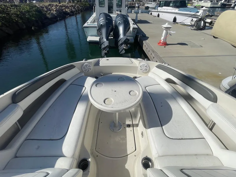 Slide: The Image of 2010 Sea Ray 260 Sundeck boat interior with seating and table at dock. - 4