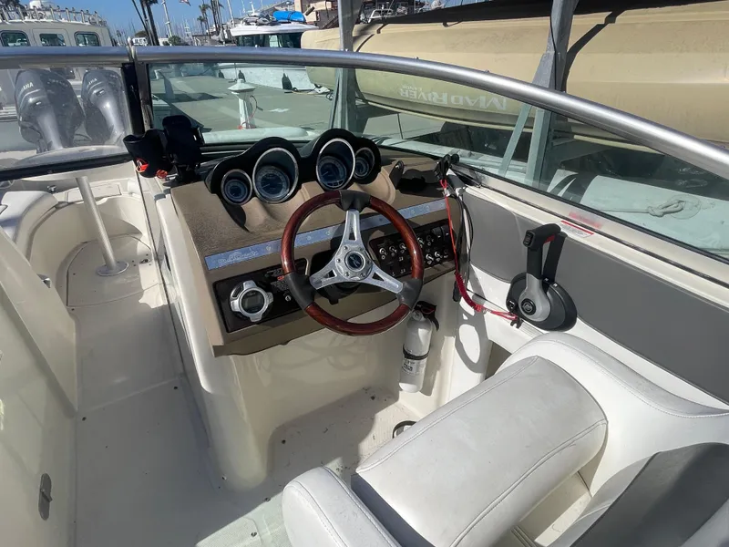 Slide: The Image of 2010 Sea Ray 260 Sundeck boat interior with steering wheel and dashboard controls. - 9