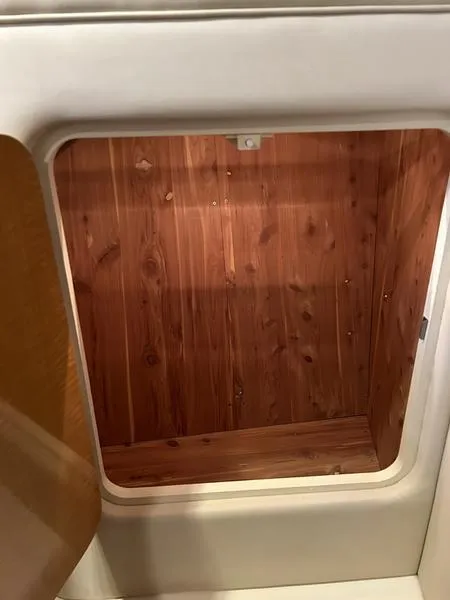 Slide: The Image of Wooden storage compartment in 2010 Larson Cabrio 370 boat interior. - 14