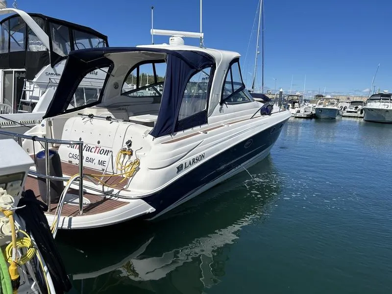 Slide: The Image of 2010 Larson Cabrio 370 boat docked in a marina under clear blue skies. - 15