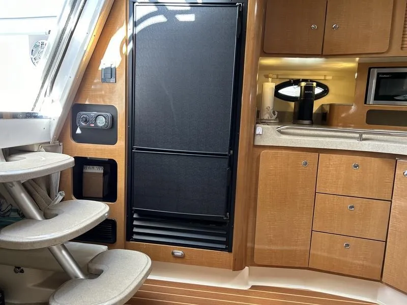 Slide: The Image of Interior of 2010 Larson Cabrio 370 yacht with kitchenette and stairs. - 18