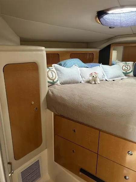 Slide: The Image of 2010 Larson Cabrio 370 cabin interior with cozy bed and storage. - 2