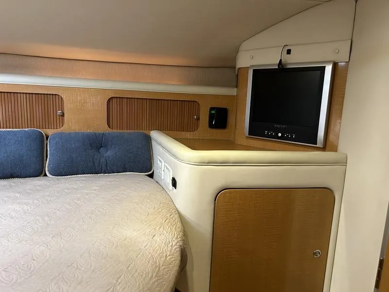 Slide: The Image of Interior of 2010 Larson Cabrio 370 yacht with bed and mounted TV. - 24