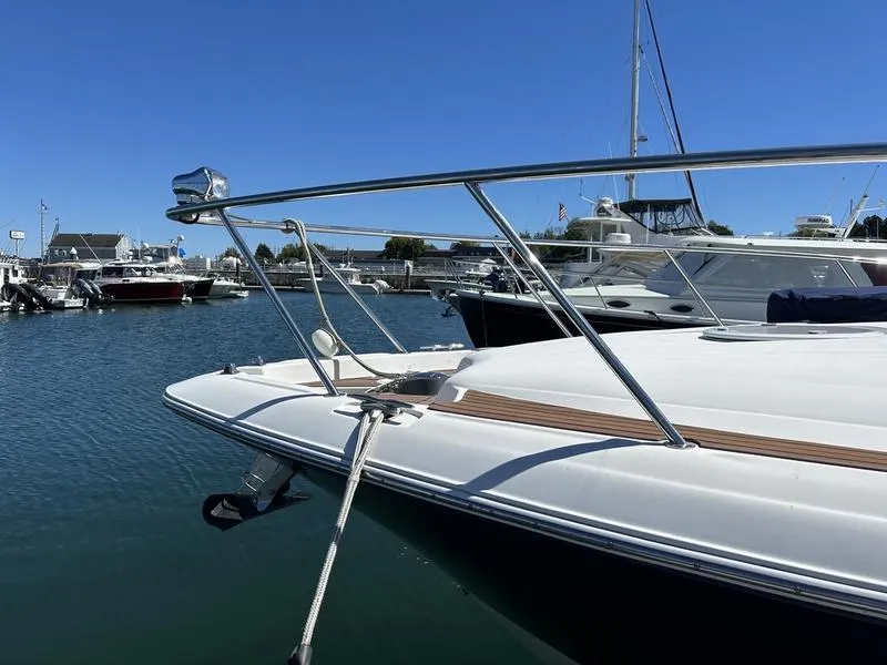 Slide: The Image of 2010 Larson Cabrio 370 yacht docked in marina under clear blue sky. - 25