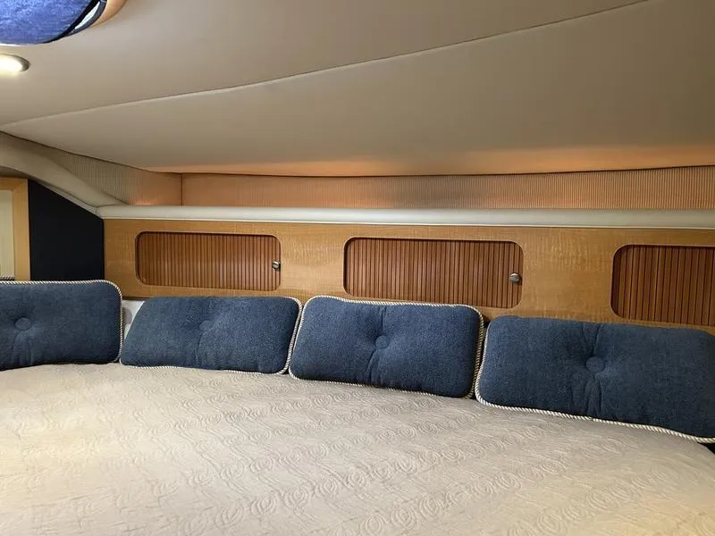 Slide: The Image of Interior cabin of 2010 Larson Cabrio 370 with blue cushions and wood paneling. - 27