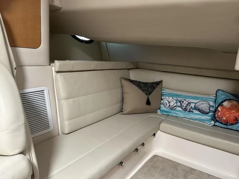Slide: The Image of 2010 Larson Cabrio 370 interior with beige seating and decorative pillows. - 29