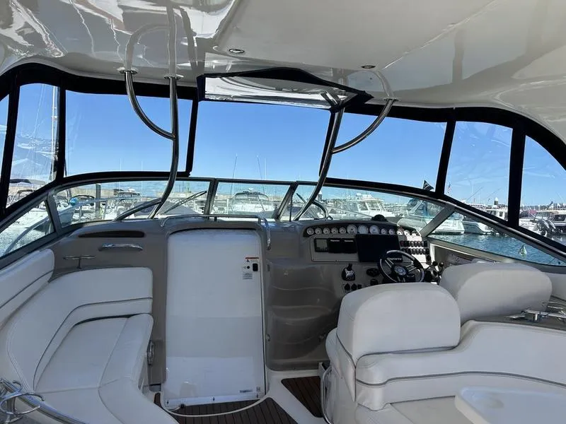 Slide: The Image of Interior of 2010 Larson Cabrio 370 yacht with white seating and control panel. - 4