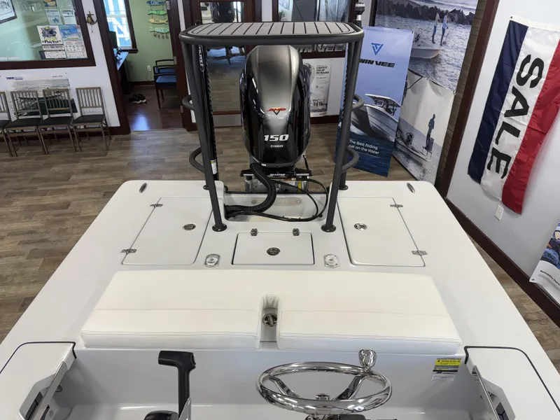 Slide: The Image of 2025 Hewes 18 Redfisher boat interior with Yamaha 150 engine in showroom. - 11