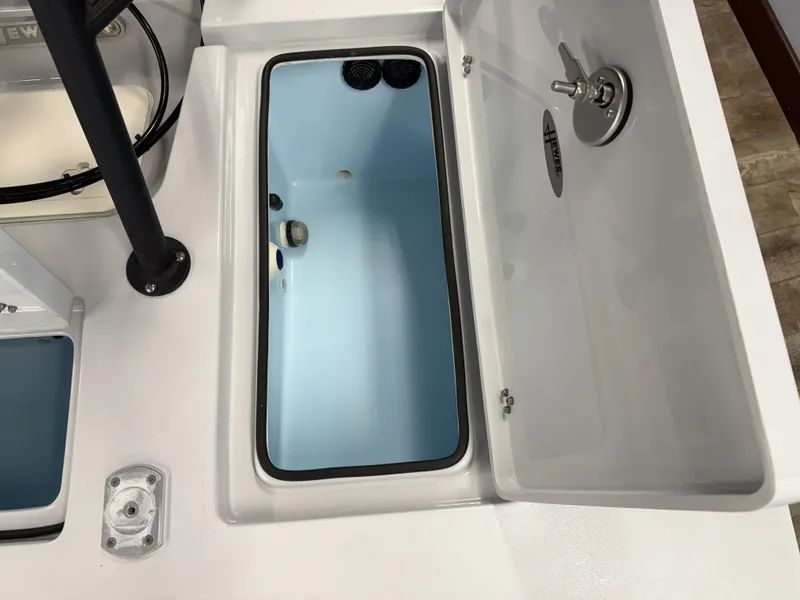 Slide: The Image of Open storage compartment on 2025 Hewes 18 Redfisher boat, showcasing interior design. - 13
