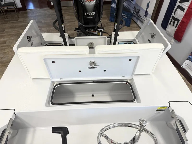 Slide: The Image of 2025 Hewes 18 Redfisher boat interior with Yamaha 150 engine and storage compartments. - 16