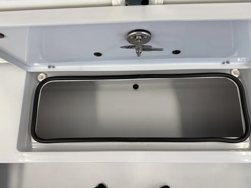 Slide: The Image of 2025 Hewes 18 Redfisher boat compartment with secure latch and gasket seal. - 17