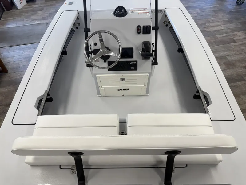 Slide: The Image of 2025 Hewes 18 Redfisher boat interior with steering wheel and seating. - 22