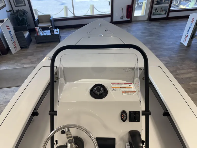 Slide: The Image of 2025 Hewes 18 Redfisher boat interior with steering console in showroom. - 23