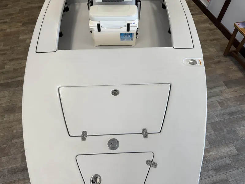 Slide: The Image of 2025 Hewes 18 Redfisher boat deck with storage compartments and cooler. - 25