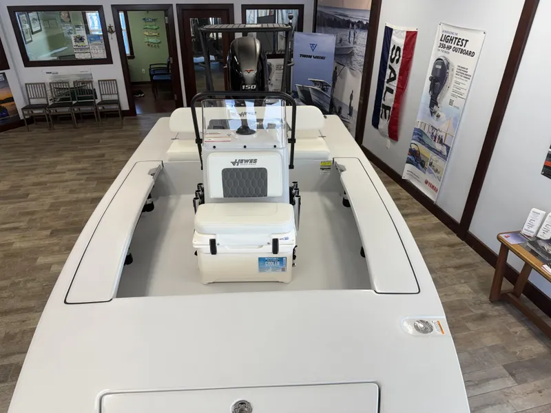 Slide: The Image of 2025 Hewes 18 Redfisher boat displayed indoors with Yamaha outboard motor. - 26