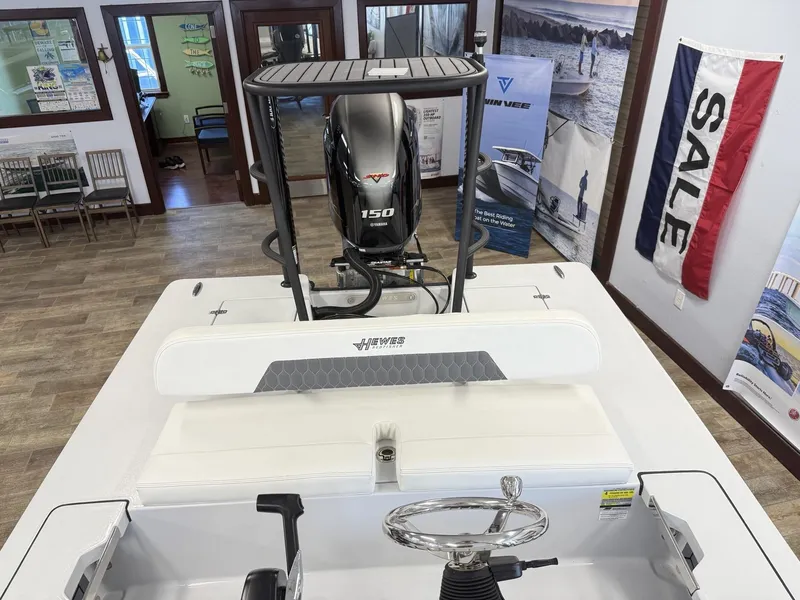Slide: The Image of 2025 Hewes 18 Redfisher boat interior with Yamaha 150 engine, showroom display. - 27