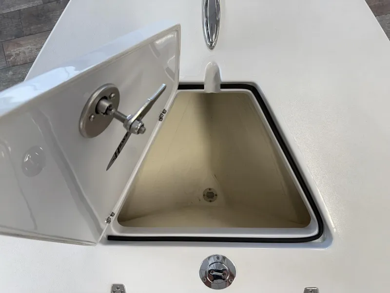 Slide: The Image of Open storage compartment on 2025 Hewes 18 Redfisher boat, showcasing interior space. - 30