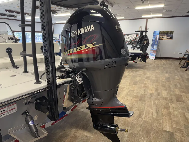 Slide: The Image of 2025 Hewes 18 Redfisher with Yamaha VMAX outboard motor in showroom. - 5