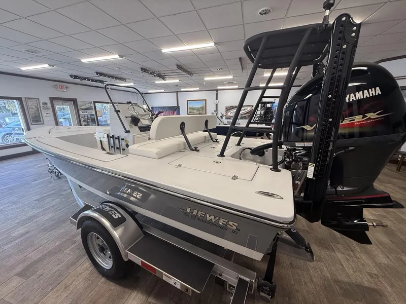 Slide: The Image of 2025 Hewes 18 Redfisher boat displayed indoors with Yamaha engine. - 6