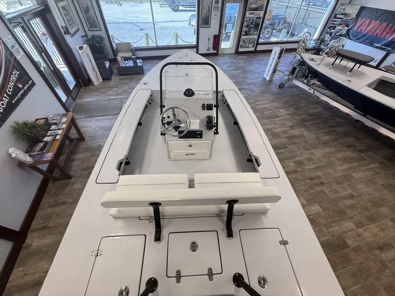 Slide: The Image of 2025 Hewes 18 Redfisher boat displayed in a showroom with modern interior design. - 8