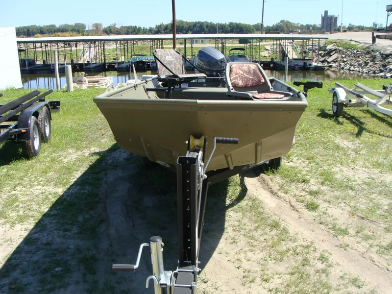 Slide: The Image of 2023 Crestliner 1648 Jon boat on trailer near a marina. - 4