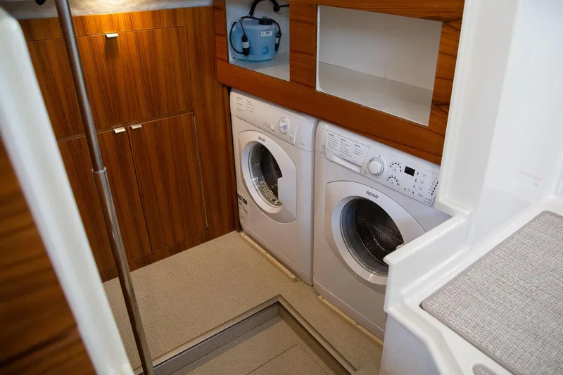 Slide: The Image of Laundry area in 2025 Ranger Tugs R-43 S boat with washer and dryer. - 14