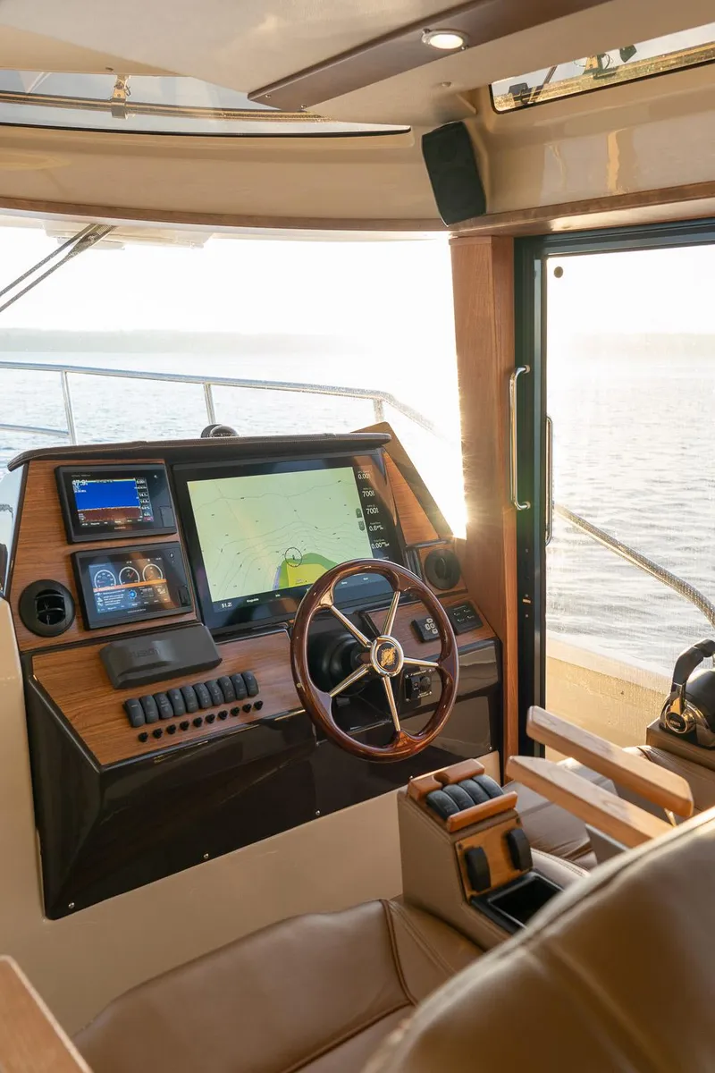 Slide: The Image of 2025 Ranger Tugs R-43 S helm with modern navigation technology and luxurious interior. - 20