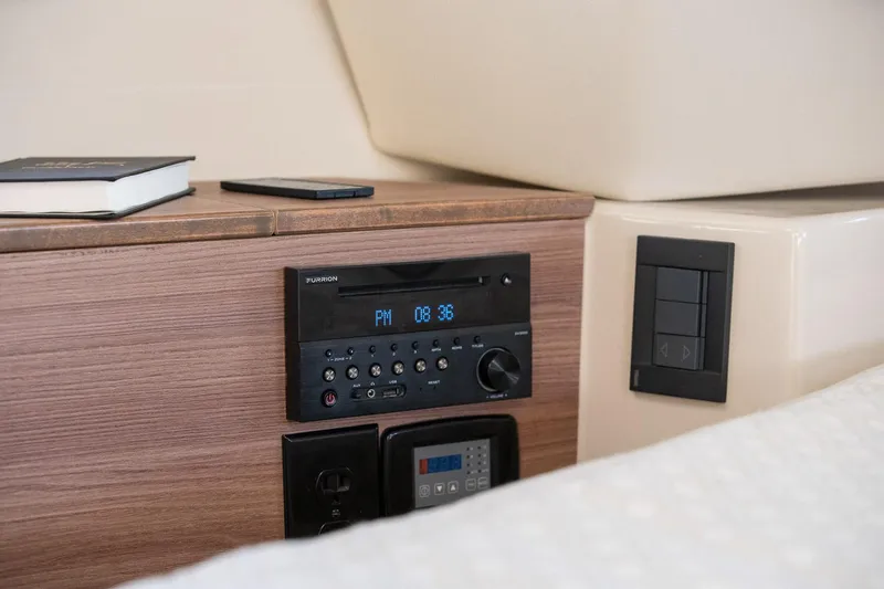 Slide: The Image of 2025 Ranger Tugs R-43 S cabin interior with control panel and wooden finish. - 23