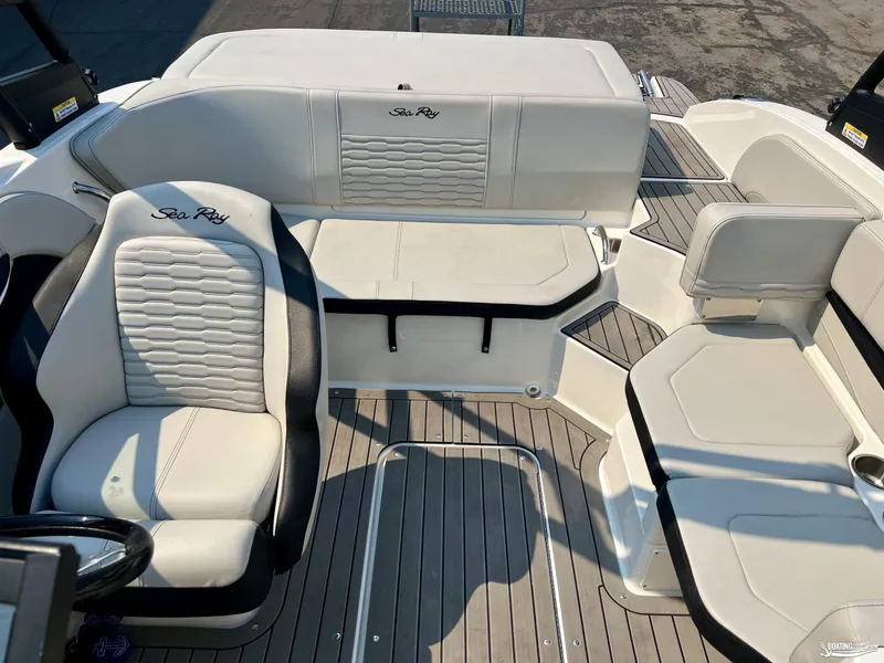 Slide: The Image of 2022 Sea Ray 190 Sport boat interior with white seating and sleek design. - 5